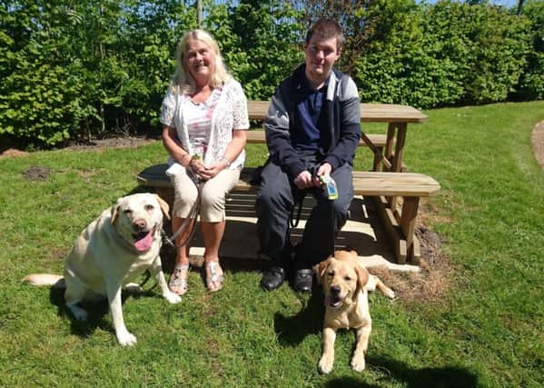 Carole Gradwell with her guide dog Rosie, and her son Liam with pup Nyki, named after Carole's daughter and Liam's sister Nyki Taylor, who died in a car crash in 2016